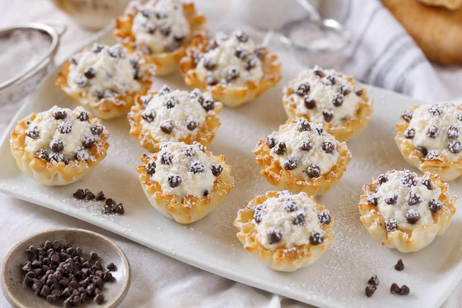 Mini phyllo cannoli cups filled with ricotta and chocolate chips