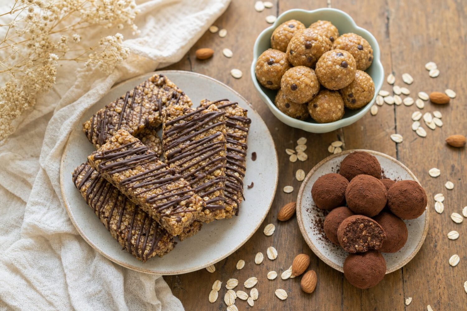 Assorted no-bake protein desserts: chocolate-drizzled oat bars, energy bites, and cocoa truffles