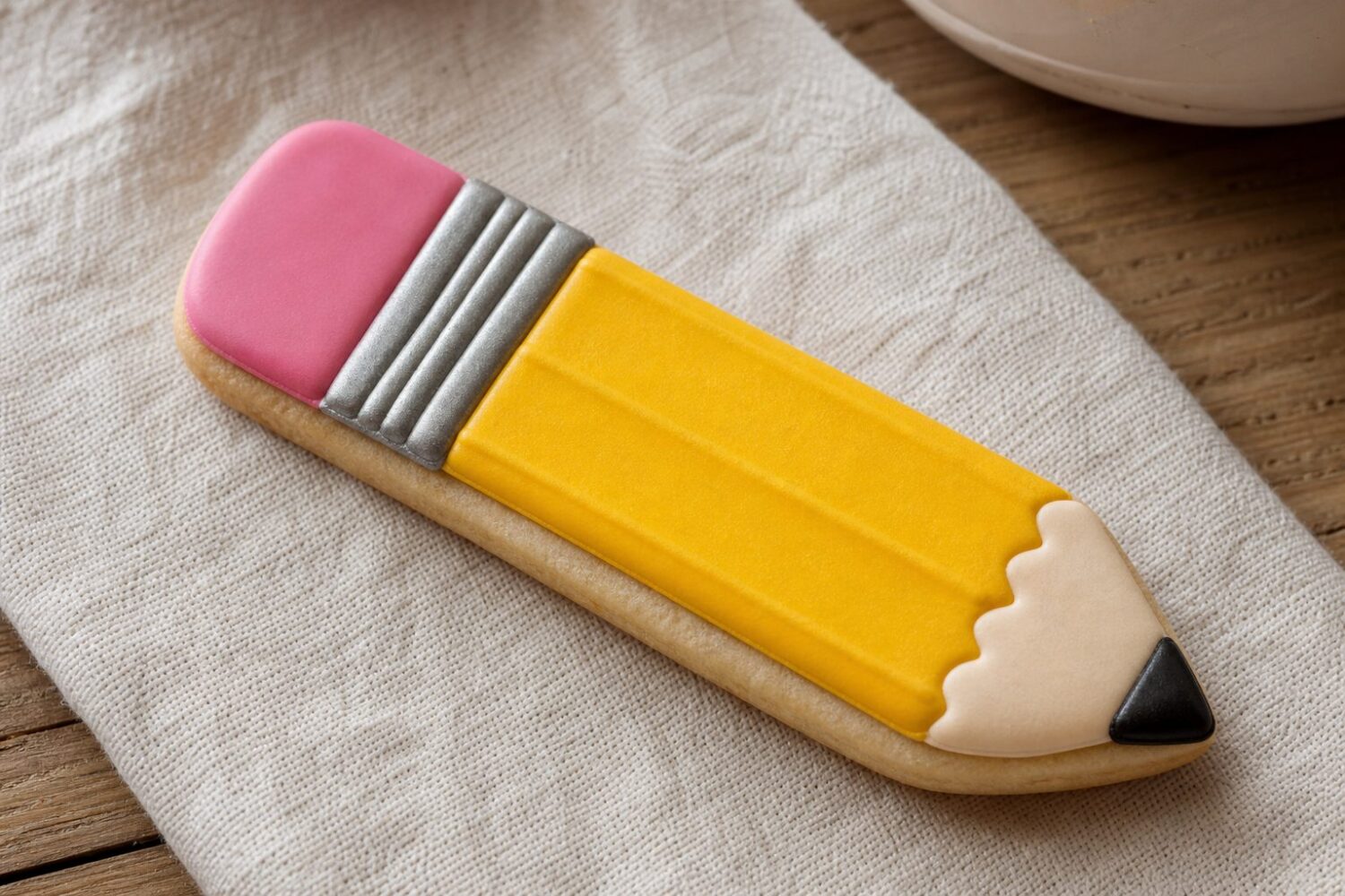 Decorated pencil sugar cookie showing four crisp royal icing bands with no colour bleed