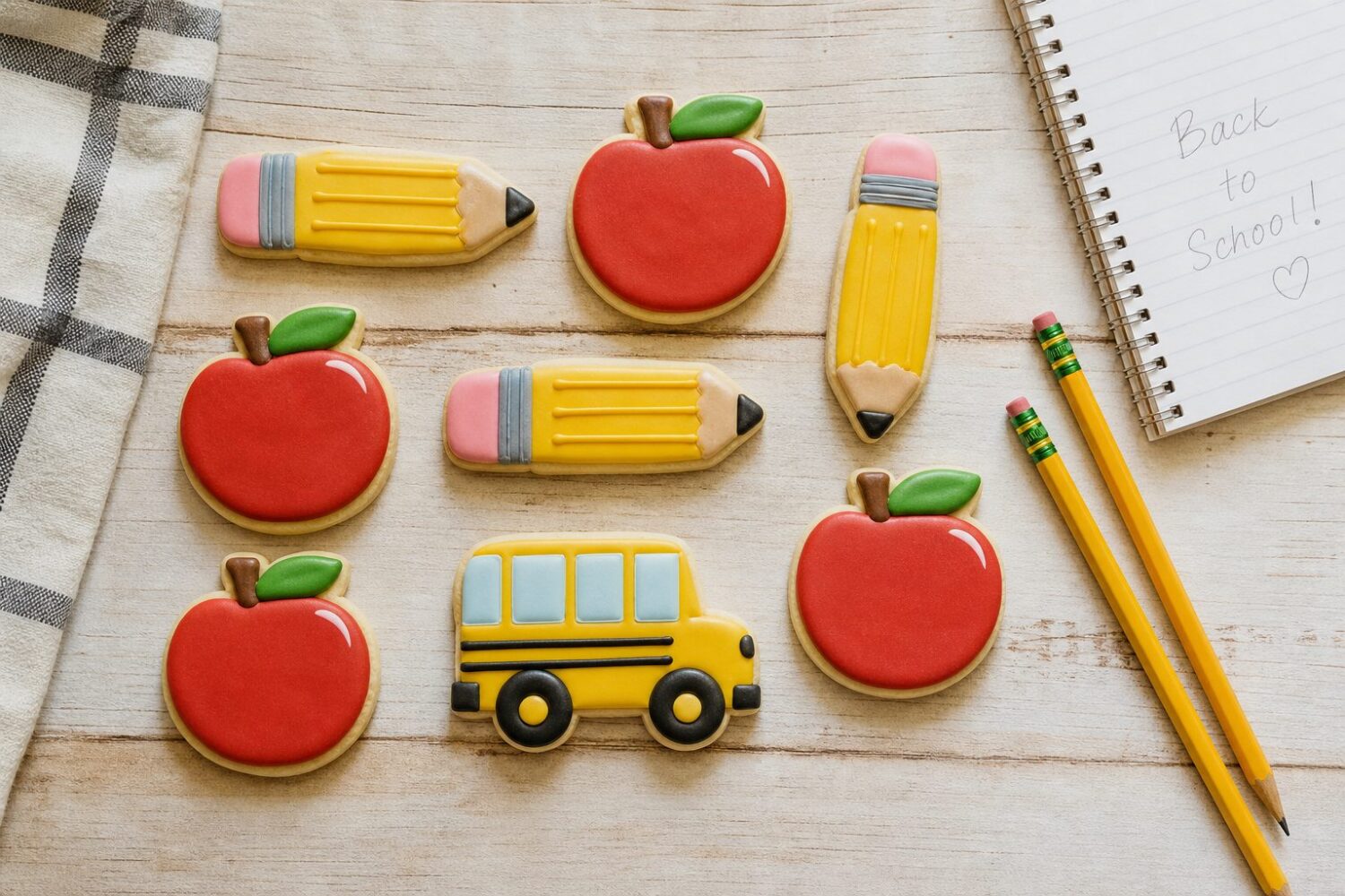 Back-to-school sugar cookie designs: pencil, apple and school bus cookies in royal icing