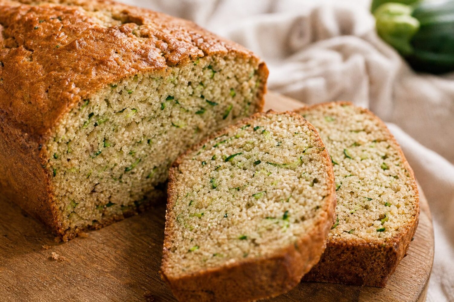 Close-up of sugar-free zucchini bread slices showing the moist crumb flecked with green shreds