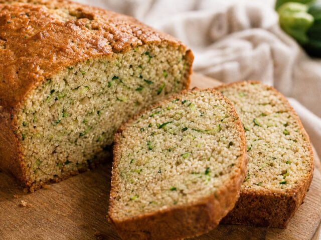 Close-up of sugar-free zucchini bread slices showing the moist crumb flecked with green shreds